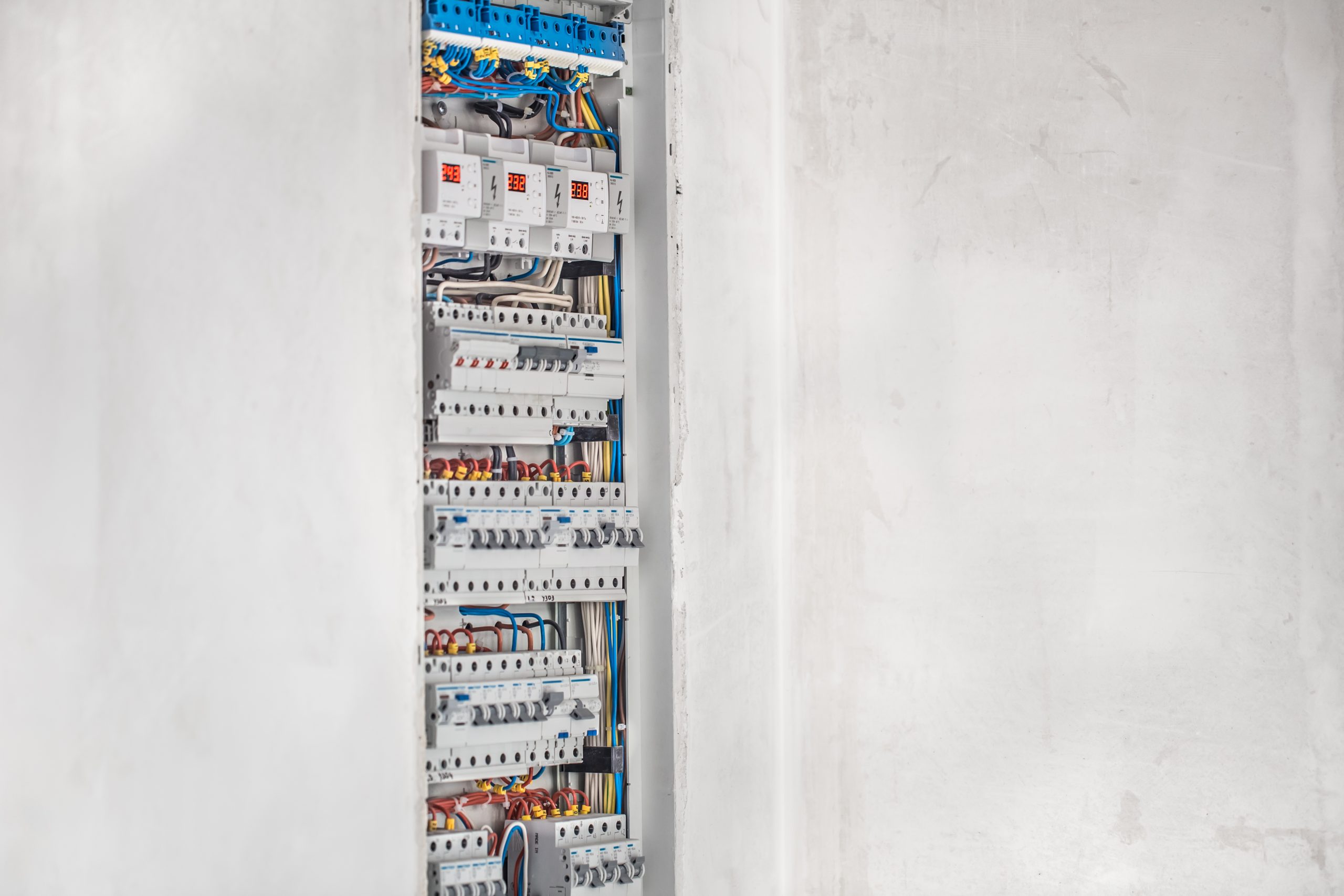 Electrician, switchboard with fuses. Connection and installation in the electrical panel with modern equipment. Concept of complex work.